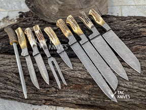 A set of custom handcrafted knives with patterned Damascus steel blades and natural antler handles, arranged on a rustic log background. The brand 'Tac Knives' is visible as a watermark and logo overlay.